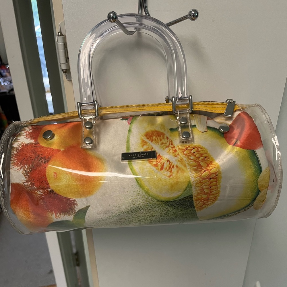 Preowned copy Kate Spade plastic covered purse with bakelite handles.